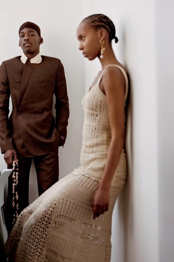 Autumn cream From left: Dior Men jacket and pants; Lemaire bandanna (held) and stylist’s own hat. Wales Bonner top and skirt, and Ulla Johnson earrings. Photography by Ronan Mckenzie.