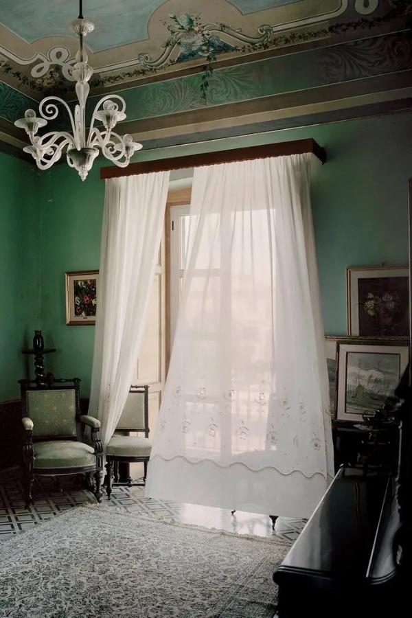 One of the living rooms of the curator Giorgio Pace’s home in Termoli, Italy, with 19th-century furniture and a chandelier by Barovier from the 1940s. Photography by François Halard.