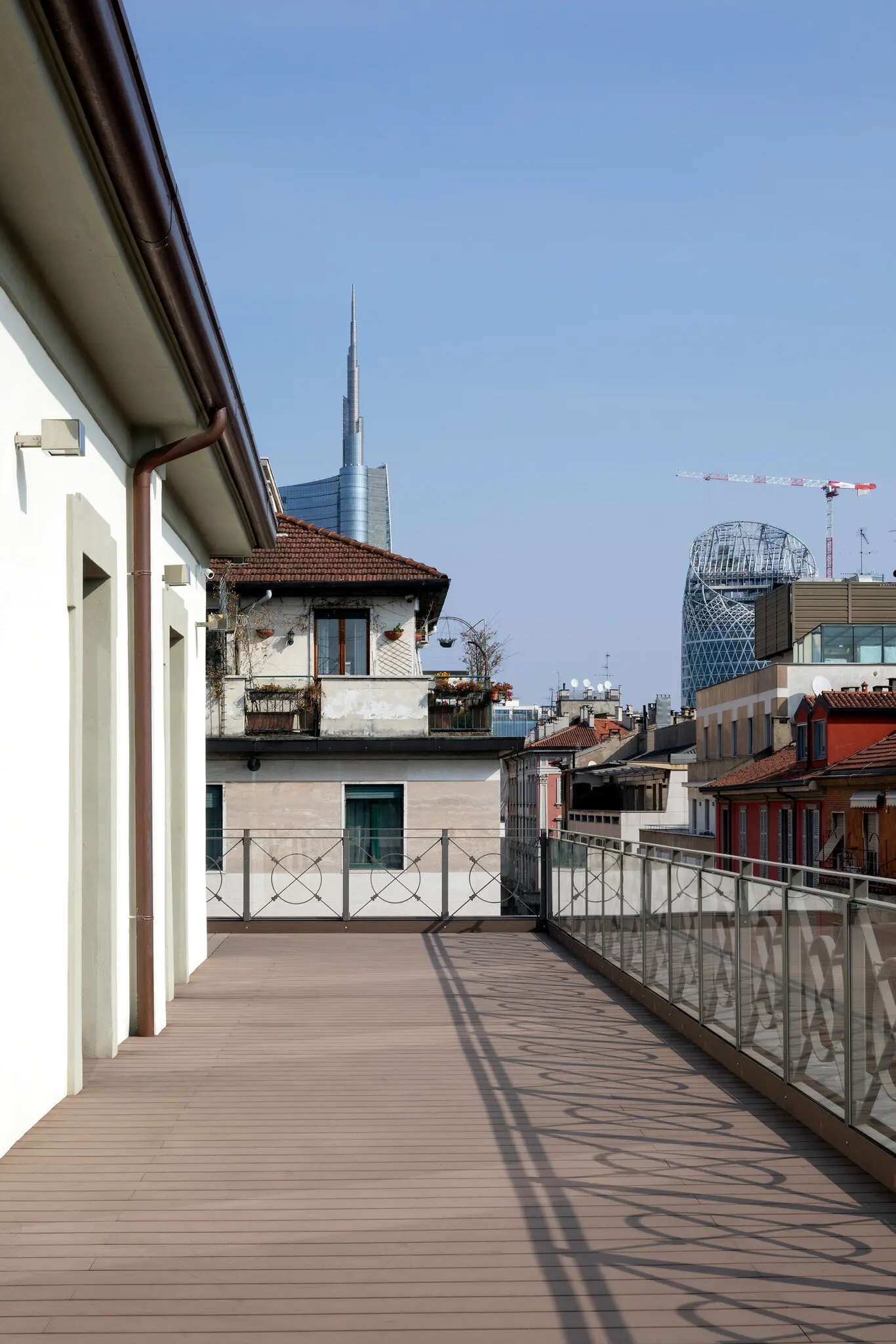 The wraparound terrace on the building’s top floor overlooks the terracotta-tiled rooftops of Milan’s Brera neighbourhood. Just beyond are the glass and steel skyscrapers of the Porta Nuova district. Photography by Allegra Martin.