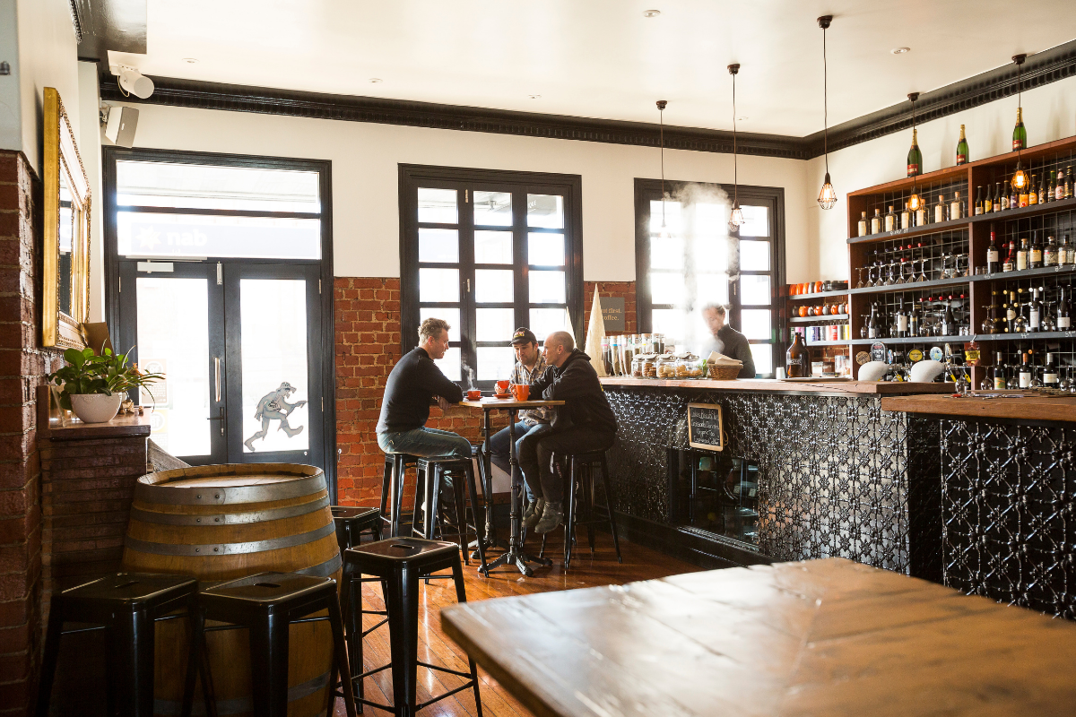 Men enjoying hot beverages at the Commercial Boutique Hotel in Tenterfield.