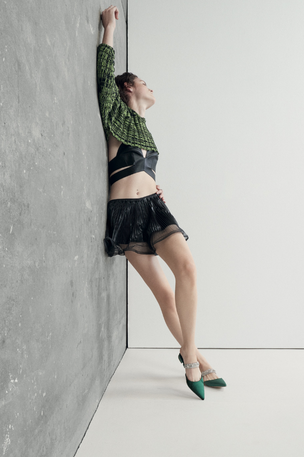 Givency top (worn underneath) and shorts, Eckhaus Latta top, and Manolo Blahnik shoes. Photography by Alessio Bolzoni.