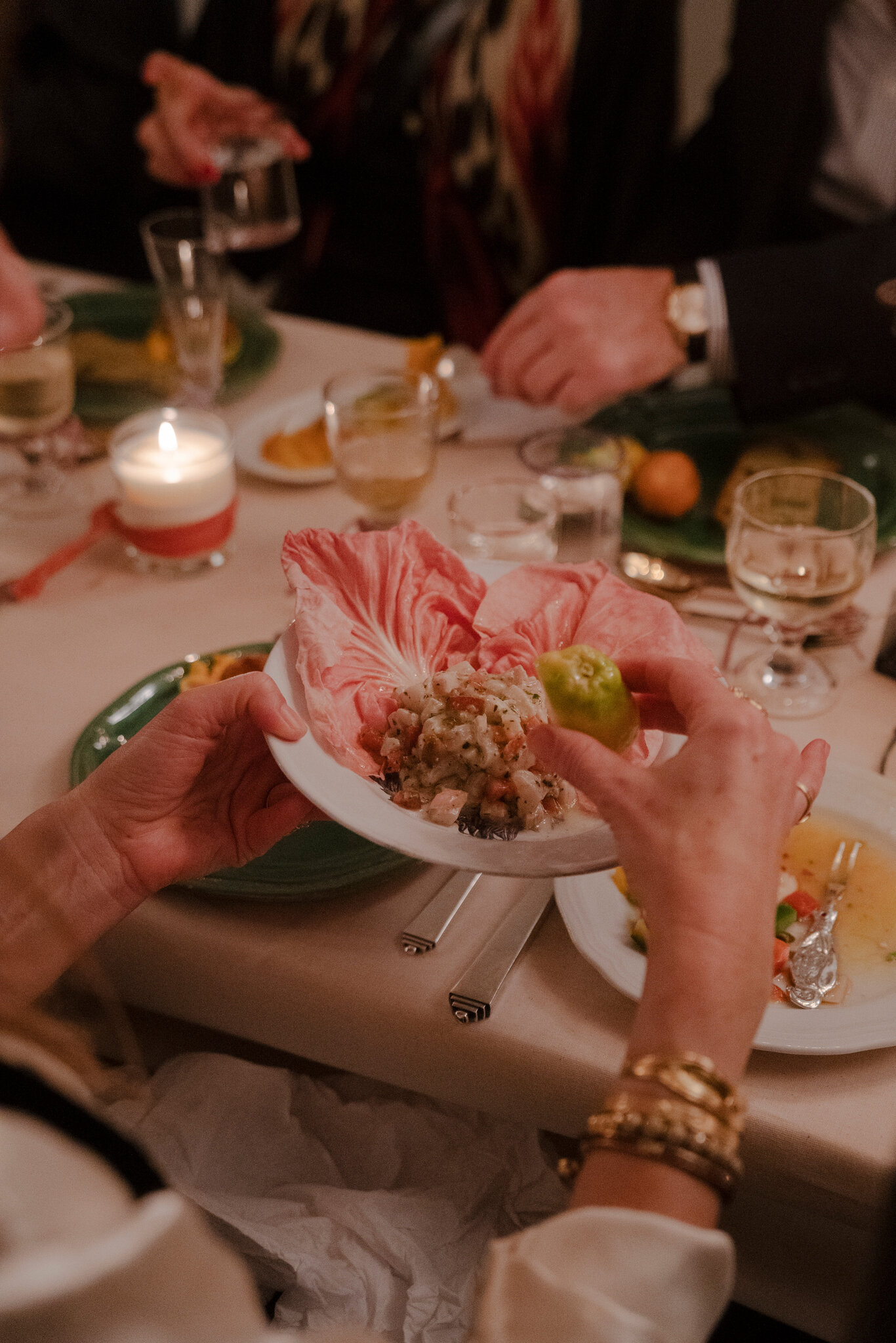 A jeweller eating food at the table.