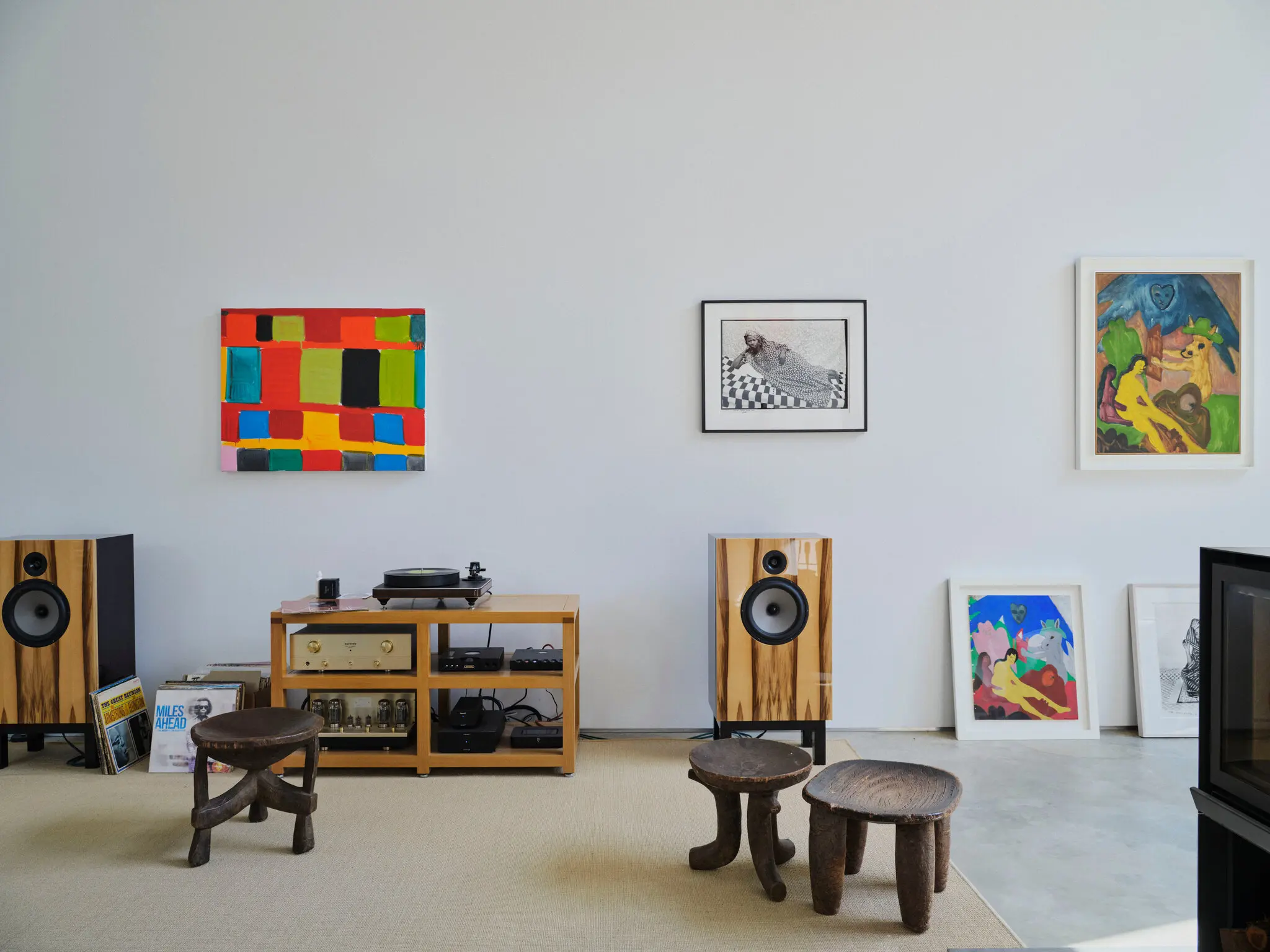 The living area features a custom stereo and artworks.